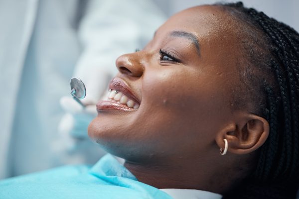 woman in dental chair looking at her teeth