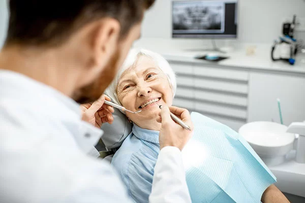 dentist prepares to operate on a comfortable, happy patient