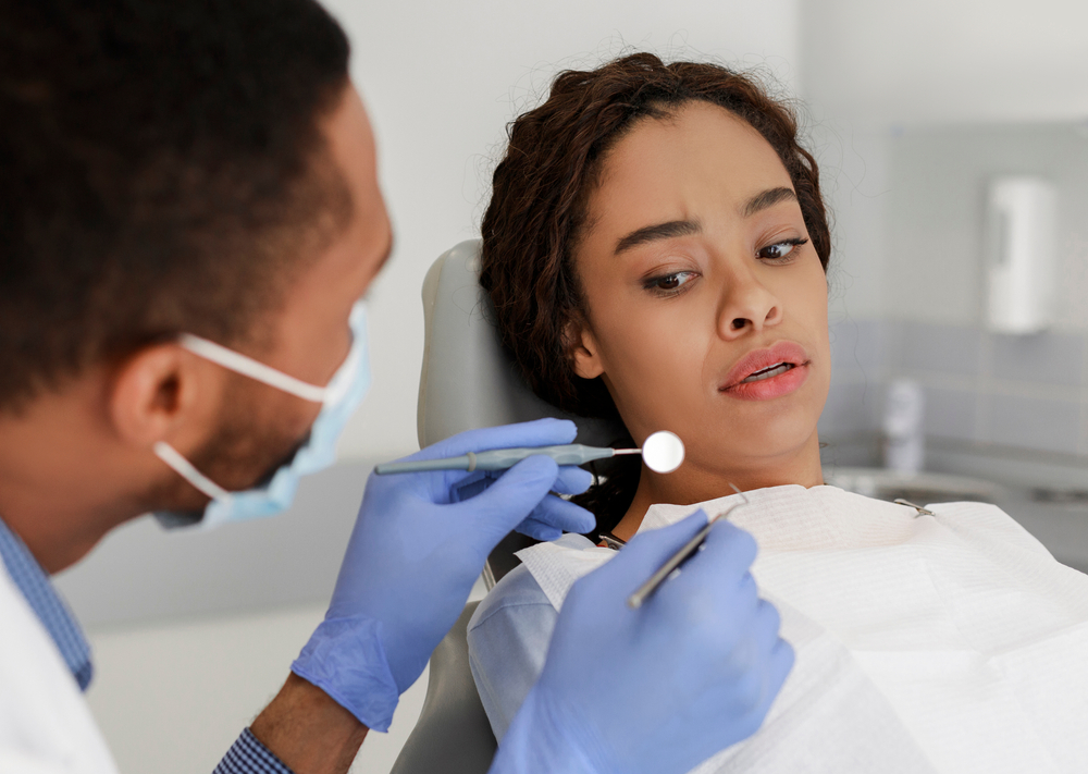 woman anxious about dental tools